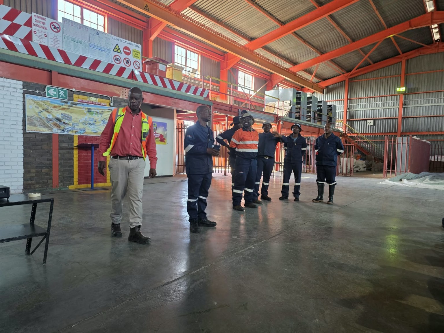 Personnel wearing workwear inside an industrial facility
