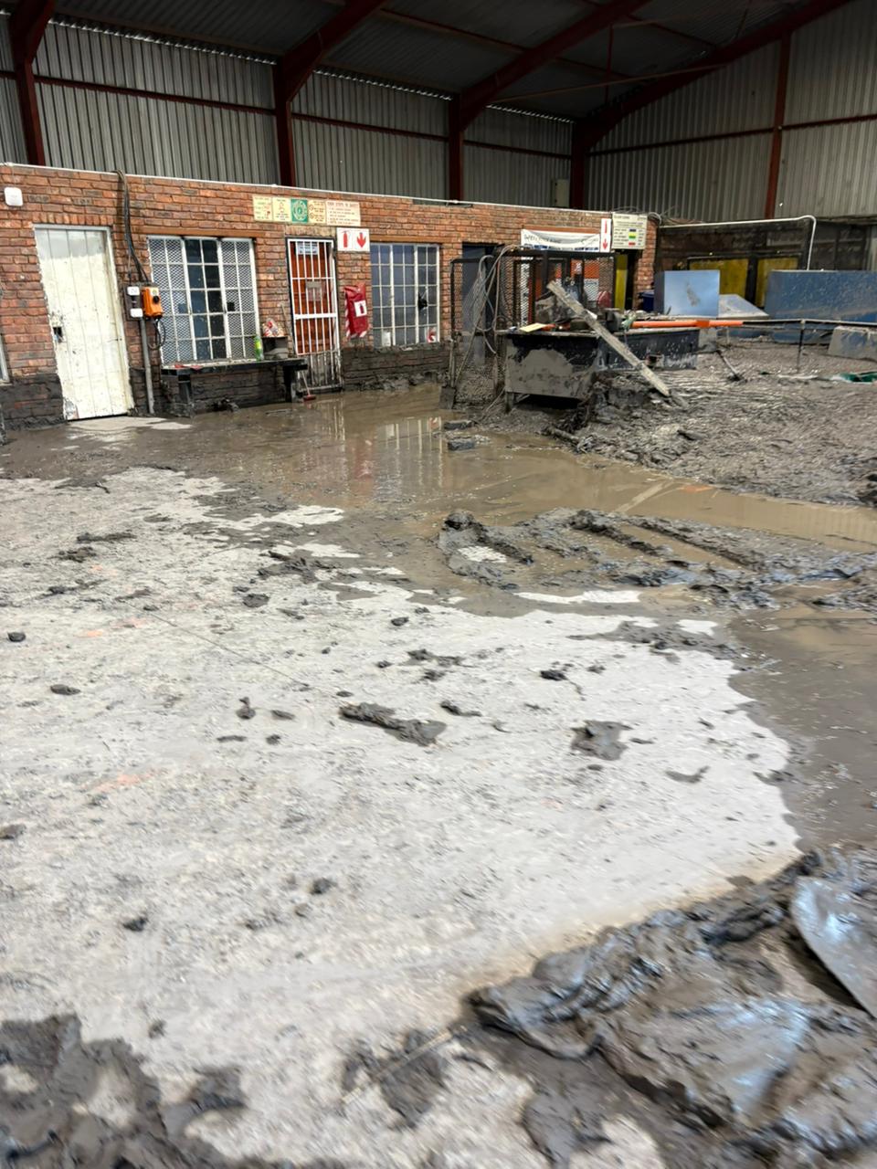Sludge and standing water around equipment inside an industrial facility